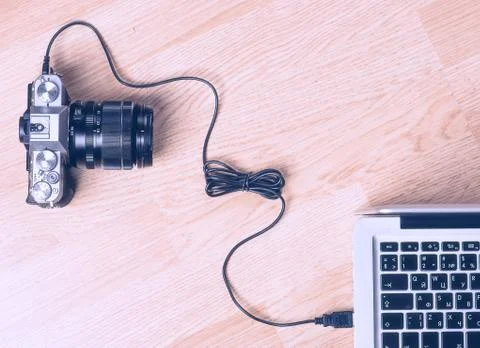 Transfer photos from camera to computer via cable. Stock Photos