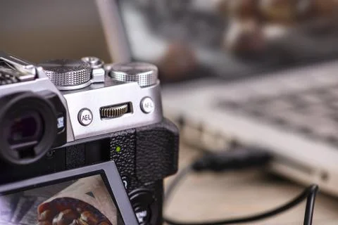 Transfer photos from camera to computer via cable. Stock Photos