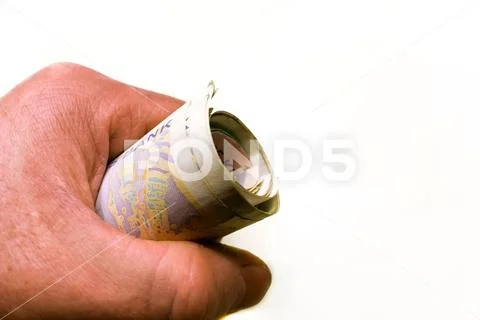 Transfer twisted banknotes. Money in hand close-up. NOK Stock Photos