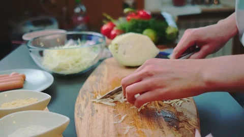 Transferring chopped cabbage to a plate Stock-Footage 249642673