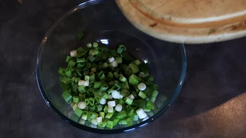 Transferring Chopped Fresh Green Spring Onions or Scallions to Bowl Stock Footage 304369836