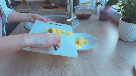 Transferring chopped potatoes from cutting board to bowl, Concept of meal Video stock 341865356