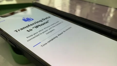 Transferring data from one iPhone to another one. Pairing iPhone exchange files Stock Footage 247241191
