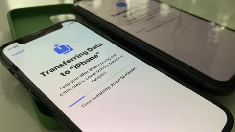 Transferring data from one iPhone to another one. Pairing iPhone exchange files Stock Footage 247241203