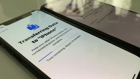 Transferring data from one iPhone to another one. Pairing iPhone exchange files Stock Footage 247241223