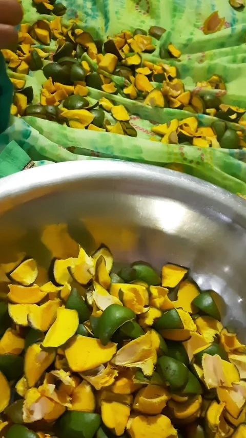 Transferring Dried Raw Mango Pieces into Bowl for Pickle Preparation Stock Footage 337712449