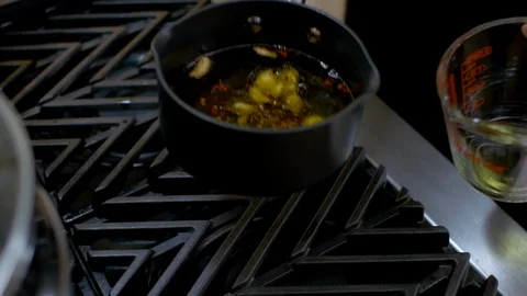 Transferring garlic oil into container Stock Footage 117539082