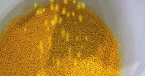 Transferring plastic granules into a container. Video stock 329180602