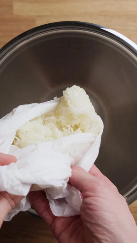Transferring Sticky Rice From Kitchen Cloth Into Bowl Vertical Top View Stock Footage 335040673