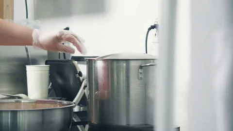 Transferring washed vegetables to a big pot on the stove Stock Footage 129993418