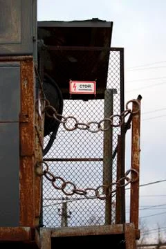 Transformer box at a height, surrounded by a chain and an inscription in Russ Stock Photos