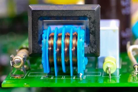 Transformer with copper winding of an electronic circuit of an electrical e.. Фото