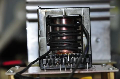 Transformer with a core wrapped in copper wire and black wire Stock Photos