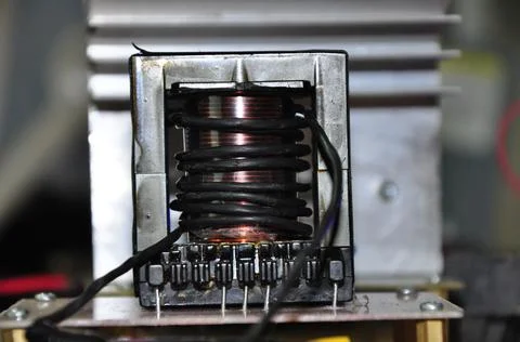 Transformer with a core wrapped in copper wire and black wire Stock Photos