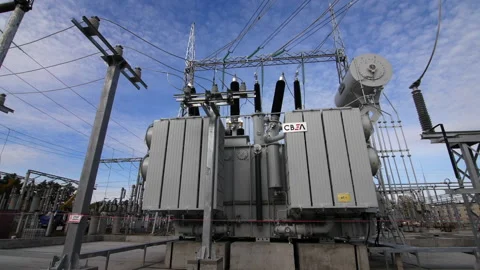 Transformer with logo and glass insulators under blue sky Stock Footage 154566843