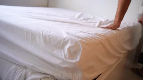 Transforming a Bed with Fresh, Clean, and Crisp White Bedding A Detailed Stock Footage 318658193