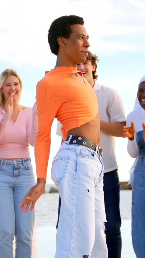 Transgender person dancing happily with multi-ethnic friends outdoors Stock Footage 256210275