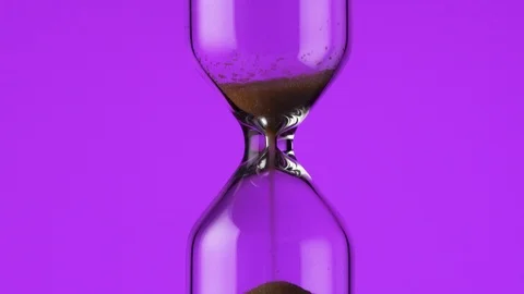 The transience of time. Hourglass on a colored background close-up Video stock 121508900