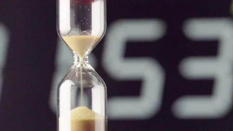 The transience of time. Hourglass on a colored background close-up Video stock 121509476