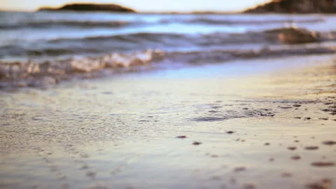 Transient Splendor: Waves Erasing Footprints on the Beach, Man Strolling at Stock Footage 239547035