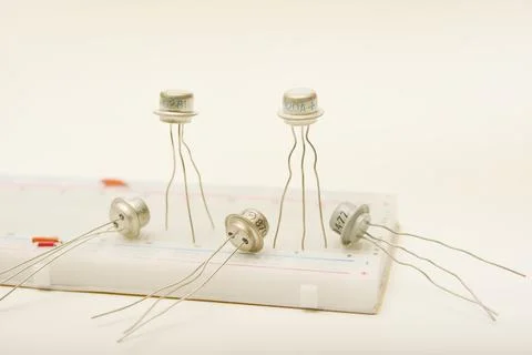 Transistors in a metal casing. Semiconductor components on a breadboard. Stock Photos