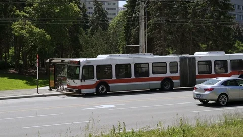 Transit Bus leaving bus stop shelter. Stock Footage 76772056