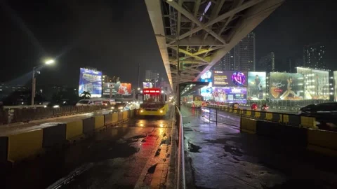 Transit bus passing by BRT lane at night with a commuter 4K 30fps Stock Footage 337950447