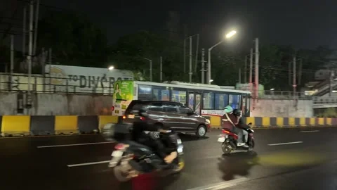 Transit buses and mixed night traffic on wet EDSA highway in Makati Stock Footage 337950513