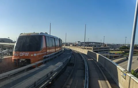 Transit in Motion: Orange Skylink Automated People Mover Monorail Train Stock Photos