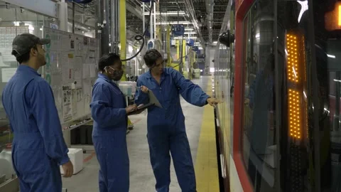 Transit workers inspecting light rail train in maintenance facility Video stock 221033693