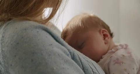 Transition around Arm of Mom Holding Sleeping Baby Stock Footage 122138095