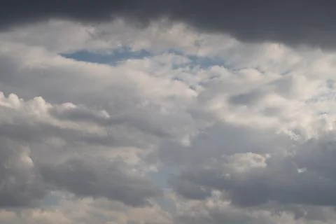 Transition clouds foreshadowing clearing, low dark layers interspersed with brig Stock Photos