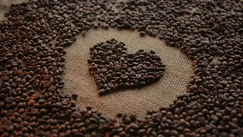 Transition from heart made of coffee beans to modern coffee sup served Stock Footage 136814969