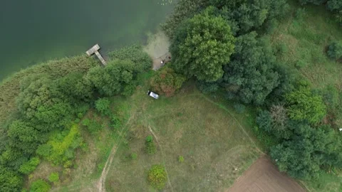 Transition pan from a grass area to a body of water Stock Footage 264758257
