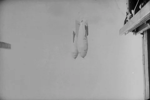 Transition shot of bombs falling through clouds, 1940s Vídeos de archivo 90727920