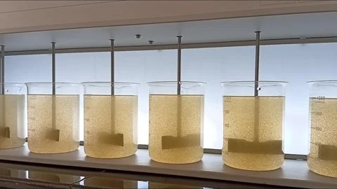 Transition from Slow Mixing to Settling in Jar Test Video stock 333298772