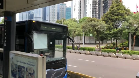 Transjakarta Bus Passing Through a Bus Stop Stock Footage 320329540