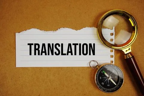 Translation text on paper torn with compass and magnifying glass on paper c.. Stock Photos