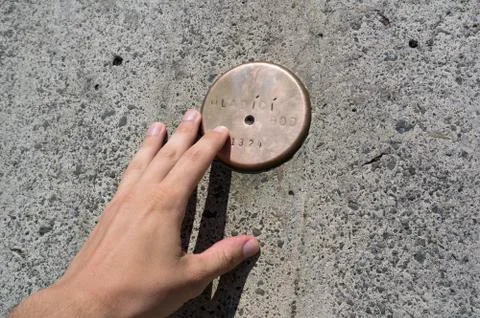 Translation: Touching point. Rounded copper spot on the monument on Lysa hora Stock Photos