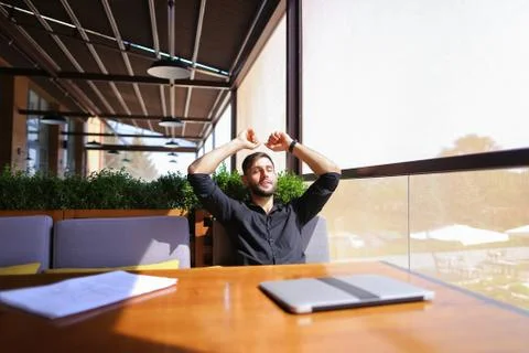 Translator sorting papers and closing laptop lid. Stock Photos