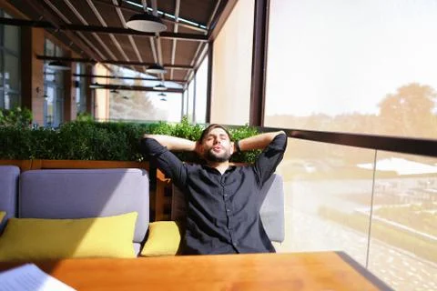 Translator sorting papers and closing laptop lid. 스톡 사진