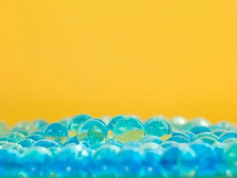 Translucent blue balls yellow background Illustrazione stock
