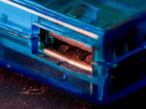 A translucent blue rectangular block shows a USB port in a dark studio sett.. Stock Photos