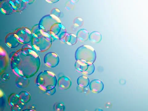 Translucent bubbles on blue background Stock Photos