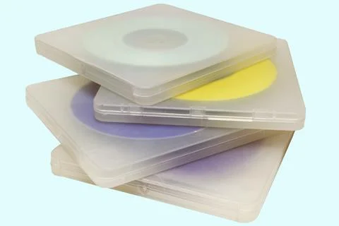 Translucent cases with disks. Stack of multicolored MIDI-discs in a regular.. Stock Photos