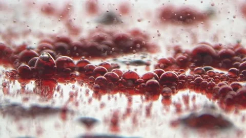 Translucent droplets of liquid fall inside the transparent liquid Stock Footage 132188734