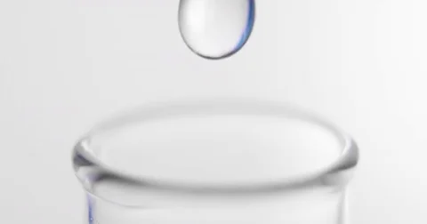 Translucent Drops are falling into test tube close up Video stock 74753580
