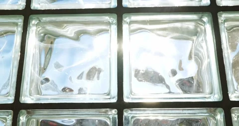 Translucent glass bricks with wavy textures and sun glare Stock Footage 332481226