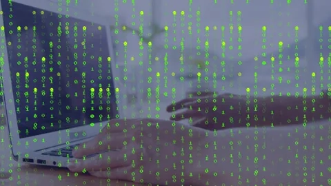 Translucent green binary overlay appearing, hands typing on laptop, showing data Stock Footage 332955921