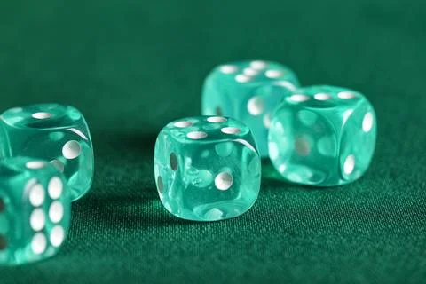 Translucent green dice on felt table, casino gambling and game night entertai Stock Photos